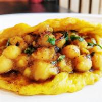 Doubles Small Eats · Lightly fried flatbread seasoned with turmeric, doubled up with a curried chickpea filling.