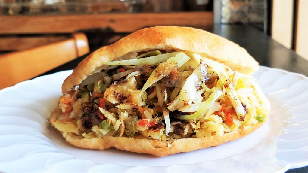 Bake & Saltfish · Lightly fried flatbread filled with shredded salted codfish, stir-fried with peppers and onions.
