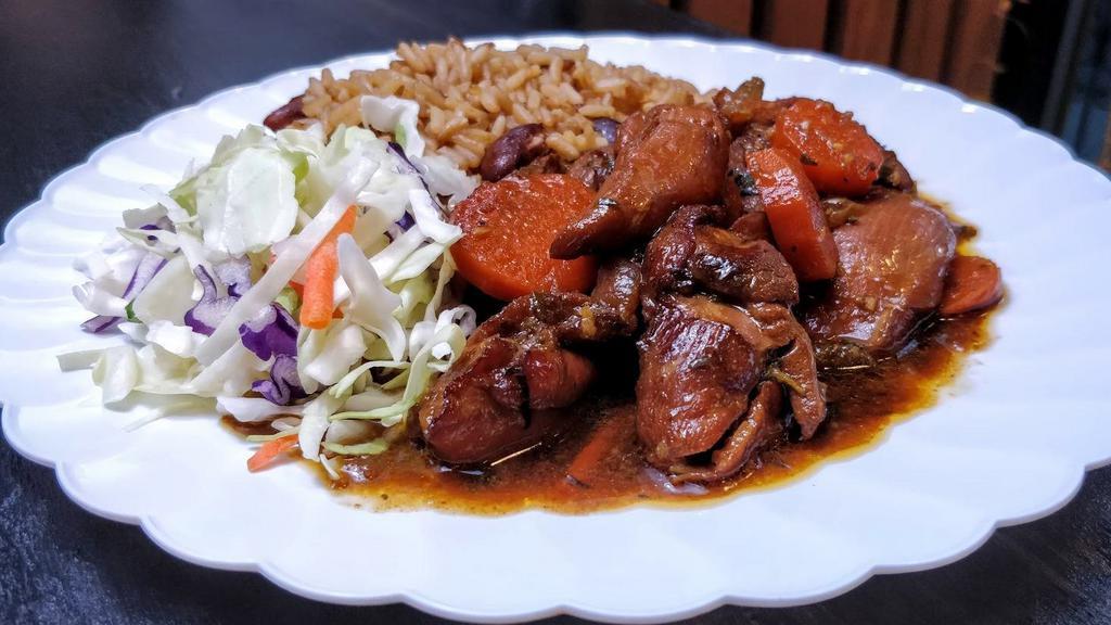 Boneless Stew Chicken With Rice & Beans · Boneless, dark meat chicken, stewed in a caramelized sugar brown sauce with carrots. Served with rice and beans and cabbage.