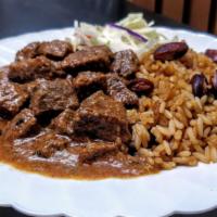 Coconut Curry Beef With Rice & Beans · Beef chuck tenderloin, slow cooked in a coconut milk curry with tamarind and aromatic spices...
