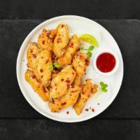Sweet Chili Sanctuary Wings · Fresh chicken wings breaded, fried until golden brown, and tossed in sweet chili sauce. Serv...