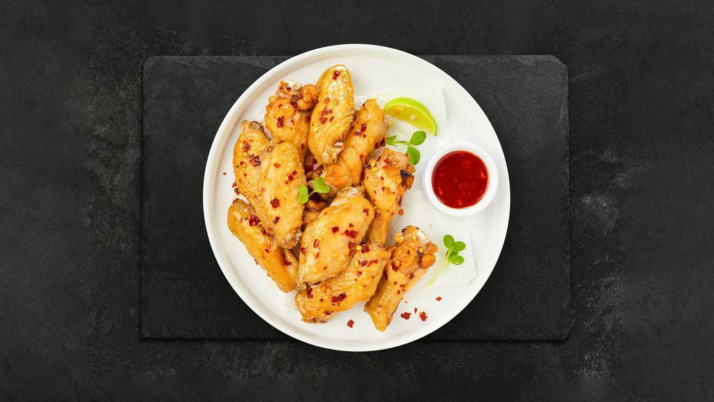 Sweet Chili Sanctuary Wings · Fresh chicken wings breaded, fried until golden brown, and tossed in sweet chili sauce. Served with a side of ranch or bleu cheese.