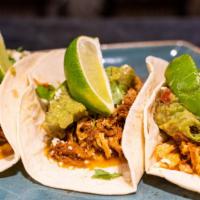 Slow Roasted Chicken Tacos · Salsa roja, guacamole, queso fresco and lime.