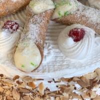 Cannoli Cake · Vanilla cake with cannoli cream filling, whip cream on the outside and cannolis on top serve...