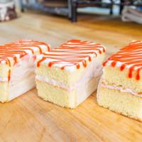 Strawberry Mouse Cake Slice · Vanilla cake with our delicious strawberry mousse topped with a layer of whip cream and a st...