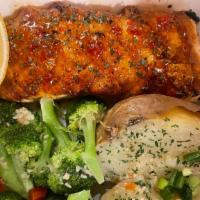Grilled Salmon · Salmon topped with our seafood sauce with choice of two sides.