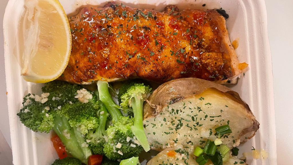 Grilled Salmon · Salmon topped with our seafood sauce with choice of two sides.