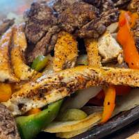 Chicken And Carne Asada Fajita · all fajitas are served with our house guacamole, sour cream, pico de
gallo, cheddar jack che...