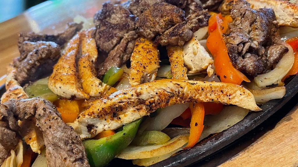 Chicken And Carne Asada Fajita · all fajitas are served with our house guacamole, sour cream, pico de
gallo, cheddar jack cheese, caramelized peppers and onions, rice,
black beans and warm corn masa tortillas