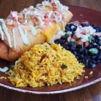 Chimichanga · deep fried flour tortilla stuffed with blackened chicken, rice, black beans and melted chedd...