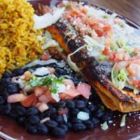 Short Rib Enchiladas · Tender pulled short rib, wrapped and baked in a tortilla topped with house made enchilada sa...