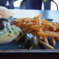 Chicano Burger · 8 oz CBS burger topped with poblano rajas, lettuce, jack cheese and mayonnaise, served with ...