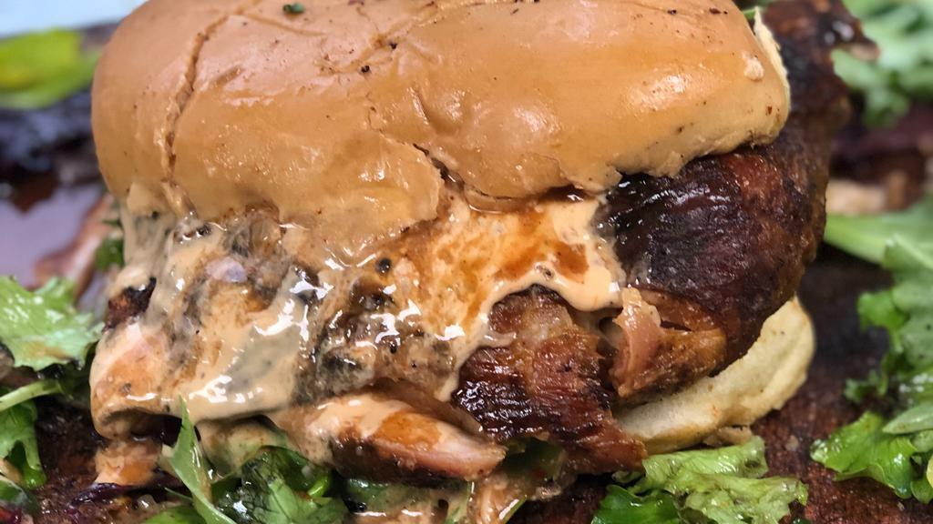 Jerk Chicken Burger · our Delicious Jerk chicken stripped off the Bone then served over Hard dough bread or  our homemade Coco bread spring mix salad and our special jerk sauce /Burger sauce
