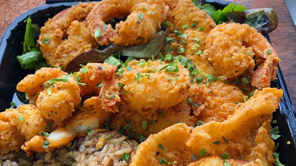 Fish & Shrimp Combo Meal · wild caught flounder Fish & Shrimp Comboserved over  mac & cheese or Rasta Pasta or Rice & Peas with steam cabbage .