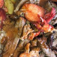 Jerk Pork & Jumbo  Shrimp · Jerk Pork &Jumbo Shrimp served over  mac & cheese or Rasta Pasta or Rice & Peas with steam c...