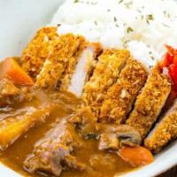 Curry Donkatsu With Rice · Panko crusted pork cutlet with curry.