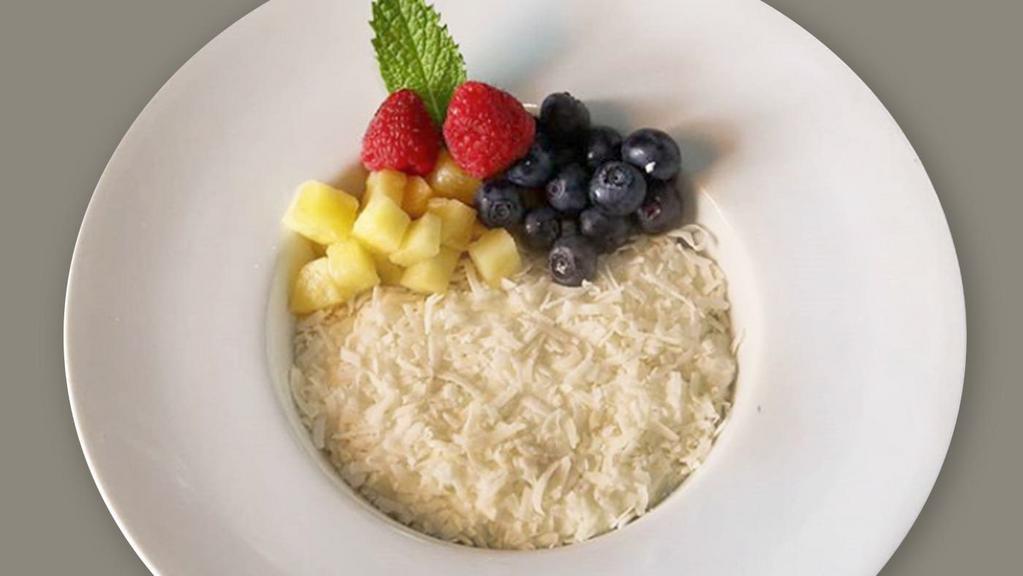 Coconut Rice Pudding · Coconut vanilla bean rice pudding topped with toasted coconut, pineapple and blueberries.