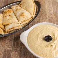 Hummus · Vegetarian. Chickpeas with tahini, extra virgin olive oil, lemon juice, cumin, and white pep...
