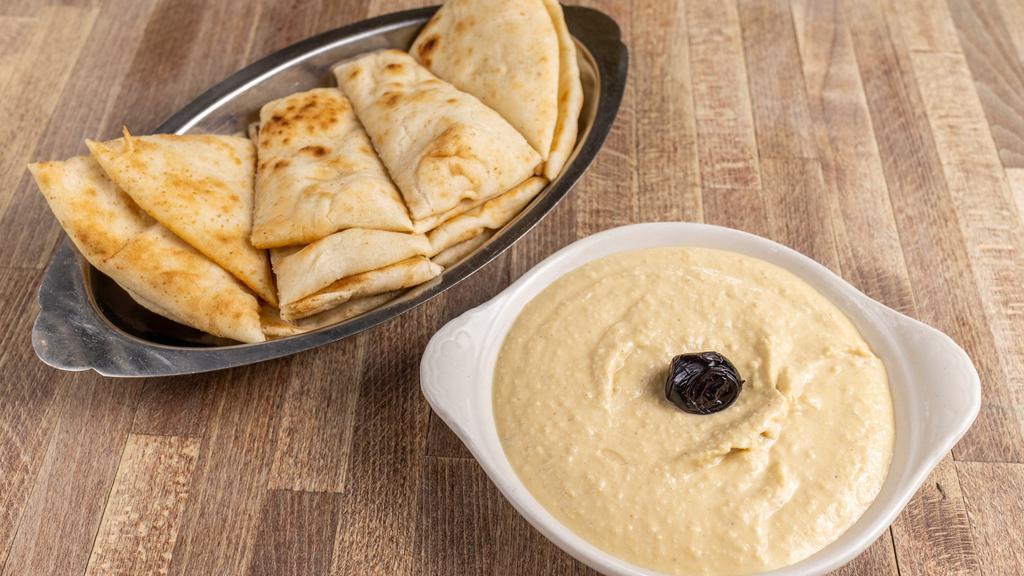 Hummus · Vegetarian. Chickpeas with tahini, extra virgin olive oil, lemon juice, cumin, and white pepper