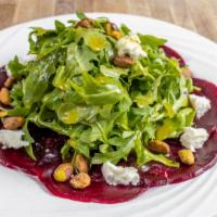 Beet Salad · Vegetarian. Beets, goat cheese, arugula, and pistachio served with olive oil and lemon