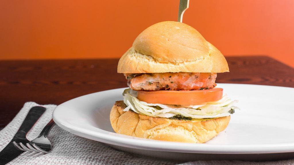 Salmon Burger · fresh salmon patty, caramelized onions, pesto, lettuce, tomatoes and pickles in a brioche bun