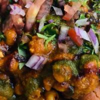 Samosa Chaat · Crisp parcels of potatoes topped with chickpeas, mint-tamarind chutney.