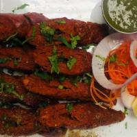 Gosht Ke Seekh Kebab · Smoked minced lamb on skewers cooked in tandoor with coriander, ginger, garlic.