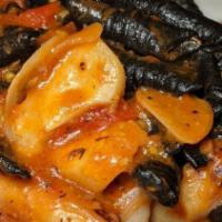 Black Garganelli · Octopus and shrimp in cognac sauce.