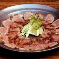Beef Tataki · Seared rare Angus Beef, daikon sprouts, apple vinegar, onion soy sauce.