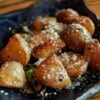 Anchovy Fried Potatoes · Fried potatoes, homemade anchovy sauce, garlic, Parmesan.