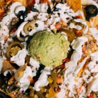 Nachos · Queso sauce, melted cheese, refried beans, pico de gallo, guacamole, crema, olives, pickoled...