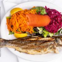 Grilled Whole Branzini · Mediterranean whole see bass, char-grilled and served with romaine lettuce, onions, and lemo...