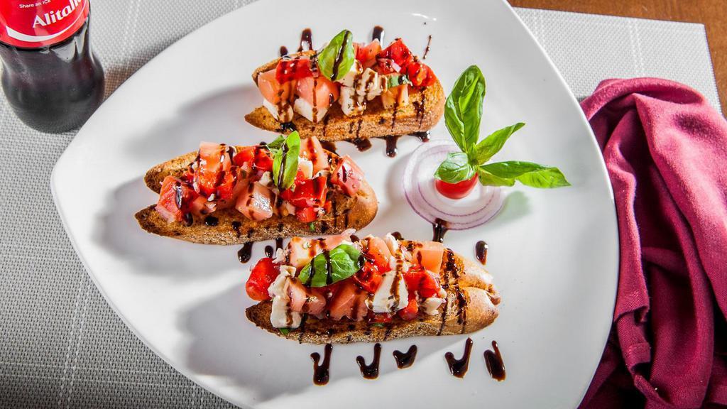 Bruschetta · Fresh mozzarella, red and white onion and garden fresh tomatoes marinated in a balsamic dressing.