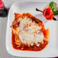 Chicken Cutlet Parmigiana · Made or covered with parmesan cheese.