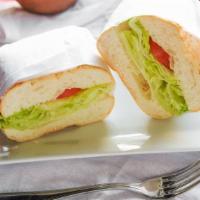 Tortas · mexican bolillo with refried beans ,lettuce ,tomatoes,avocado ,oaxaca cheese,onion and jalap...
