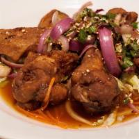 Kai Zabb · Crispy spicy chicken wings mix with red onion, mint in spicy tamarind sauce.