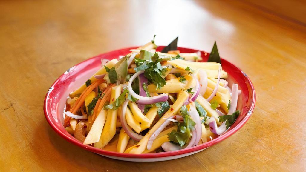 Yum Mamuang · Mango, red onion, cilantro, avocado tossed w/ house spicy dressing topped w/ dry crispy anchovies.