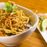 Kao Soi · Egg noodles with chicken or vegetables simmered in curry soup, topped w/ crispy egg noodles,...