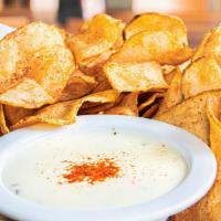 Old Bay Kettle Chips With Queso · This addictive shareable is perfect for the whole team.  Our veteran crispy kettle chips sea...