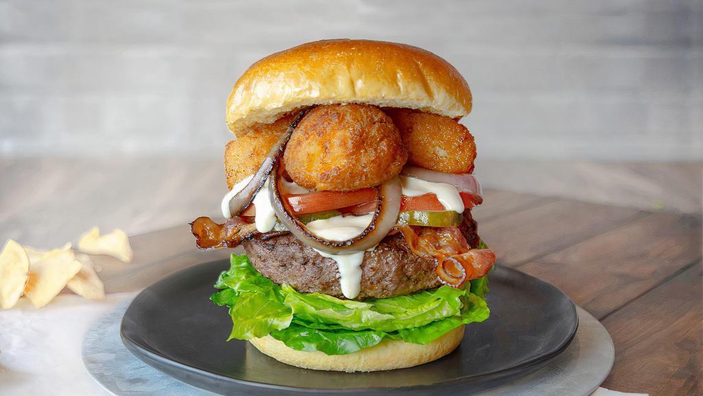 Macdaddy Burger · A signature all-beef patty, topped with fried mac n cheese bites, grilled onions, crispy bacon, tomato, lettuce and pickles smothered in queso on a brioche bun. Served with a side item. (1410-1830 cal.)upgrade to a premium side or house or Caesar side salad.