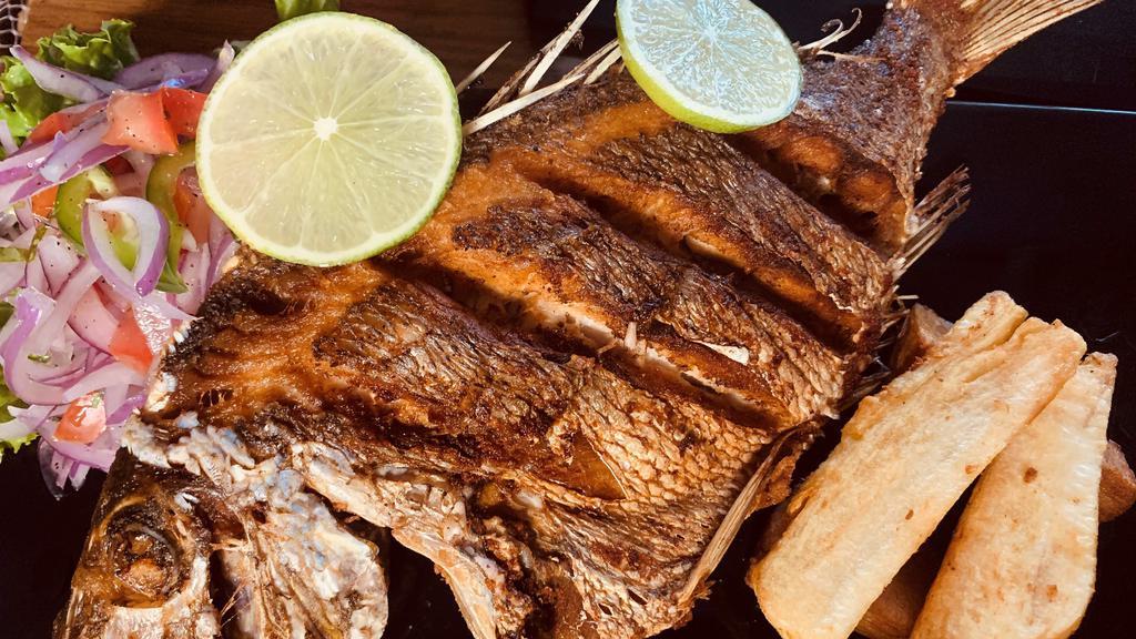 Pescado Pargo · Fried whole red snapper fish, served with homemade salad and white rice