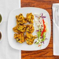 Vegetable Pakoras · Mixed vegetables fritter batter with mild spices and shallow fried to golden perfection.