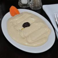 Hummus · Mashed chickpeas and tahini blended with garlic and lemon juice.