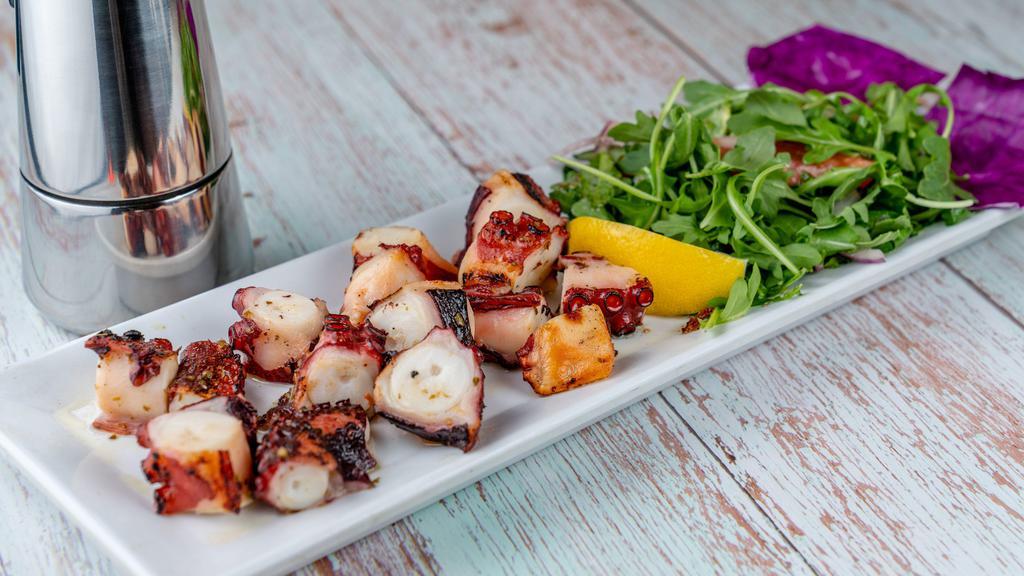 Octopus Salad · Char-grilled octopus legs served with mixed greens.