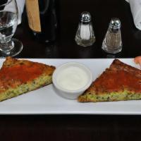  Zucchini Pancakes · Pan-fried zucchini pancakes topped with red sauce and served with yogurt.