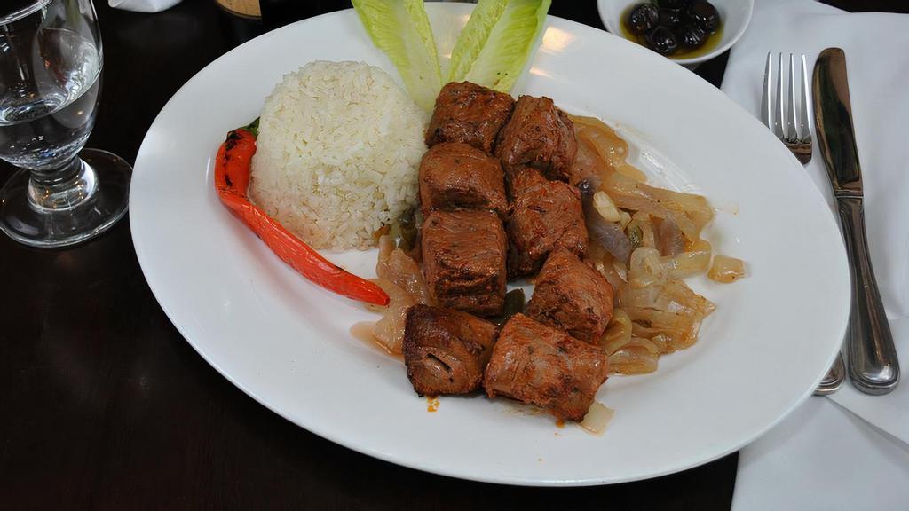 Lamb Shish · Char-grilled tender cubes of lamb. Served with rice pilaf and garnish.
