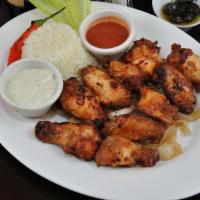 Chicken Wings · Char-grilled chicken wings served with blue cheese dressing and hot sauce.