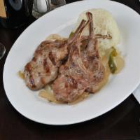 Lamb Chops · Char-grilled four pieces of baby lamb chops. Served with rice pilaf and garnish.