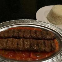  Hashas Kebab · Grilled adana kebab over chopped tomato and pepper sauce. Served with rice pilaf and garnish.