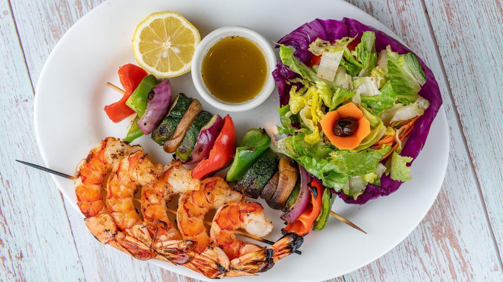 Grilled Shrimp · Grilled marinated jumbo shrimps with grilled vegetables on skewers. Served with green salad.